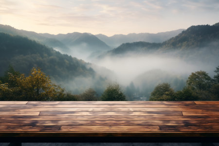 Wooden table overlooking a misty mountain valley at sunrise.の素材