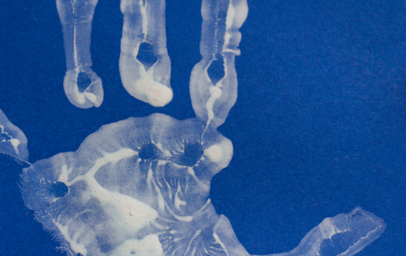 Palm or  handprints on a blue backgroundの写真素材