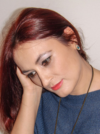 The Pensive Lady indoor shot on white undergroundの写真素材