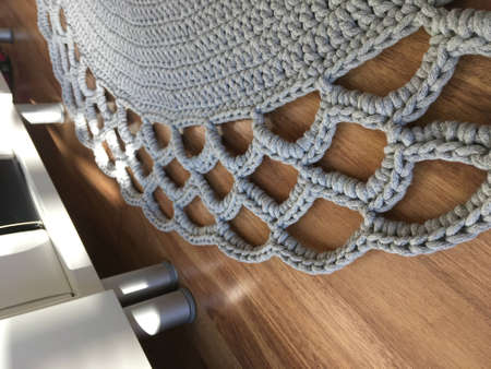 Crochet rug, colored balls as a background.