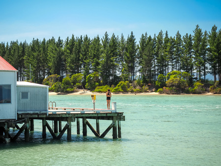 A girl is waiting to jump form the Mapua Wharf. (NZ)の写真素材