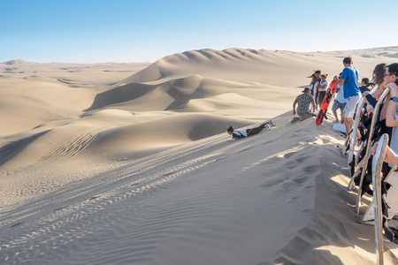 Huacachina, Peru - Oct 2, 2017: Tourists are joining the most famous tour, the sandboarding.のeditorial素材