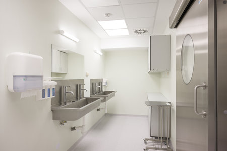 Modern Hospital Scrub Room with Stainless Steel Sinks and Doorの写真素材