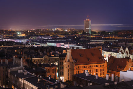Nighttime Cityscape with Historic Buildings and a High-Riseの写真素材