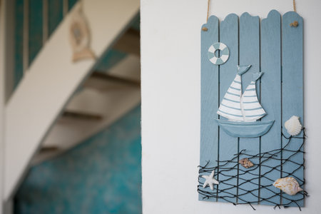 Nautical Themed Wall Decoration with Sailboat and Shellsの写真素材