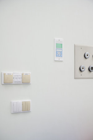 Various Control Panels and Electrical Switches on a White Wallの写真素材