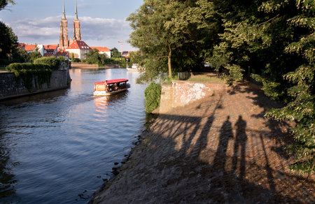 City Scene with Shadows, a Canal and Tour Boat in Wroclaw.の写真素材