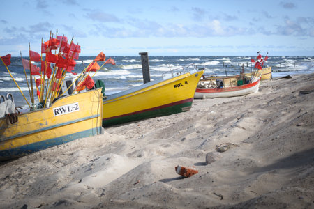 Fishing Boats on a Sandy Beach with Seagullsの写真素材