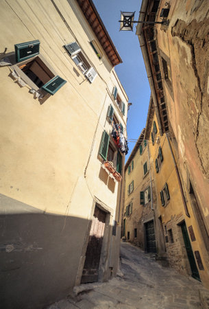 Narrow European Street with Laundry and Shutters. Cortona Italy.の写真素材
