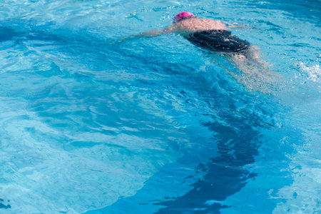 Woman Swimming in a Blue Pool: Summer Relaxation. close-up.の写真素材