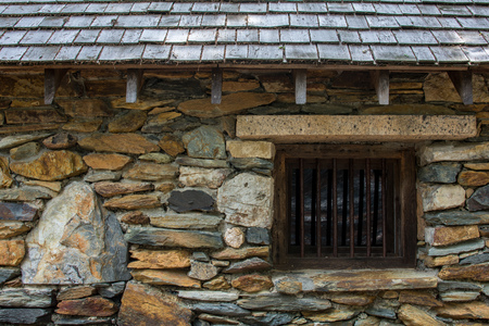 Old Jail: Stone wall and barred window. Close up.の写真素材