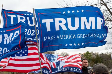 CHARLOTTE, NORTH CAROLINA/USA - February 7, 2020: Trump flags fliy in the stiff wind awaiting Presdient Donald Trump's visit to Charlotte, North Carolina on February 7, 2020のeditorial素材
