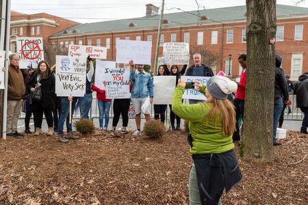 CHARLOTTE, NORTH CAROLINA/USA - February 7, 2020: Organizer takes a photo of protesters as they await the arrival of Presdient Donald Trump for a rally in Charlotte, North Carolina on February 7, 2020のeditorial素材