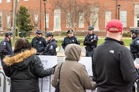CHARLOTTE, NORTH CAROLINA/USA - February 7, 2020: Charlotte police officers watch a small group of...