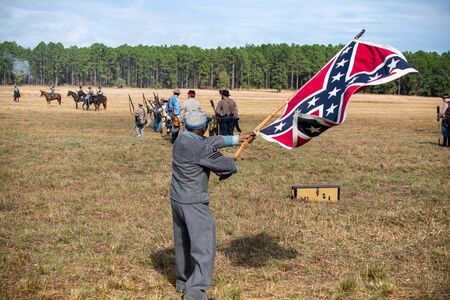 Brooksville, FL - January 19, 2020: An African-American Civil War Reenactor waves a large confederate flag at the reenactment of the Brooksville Raid, in Florida.のeditorial素材
