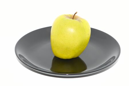 Green apple on the black plateの写真素材