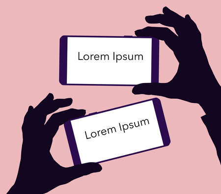 Silhouetted hands holds two cellular phones with  lighted but blank screen with blank copy space.の写真素材