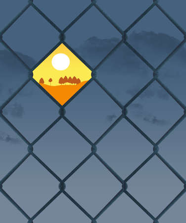 A sunset is seen through one opening in a chain link fence on a cloudy dark day.の写真素材