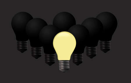 One light bulb is lit while others remain dark to illustrate people getting ideas.の写真素材