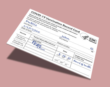 A Covid-19 Vaccination Record Card that is generic and filled out with John Q Publicâs name is held by a hand in this 3-D illustration.の写真素材