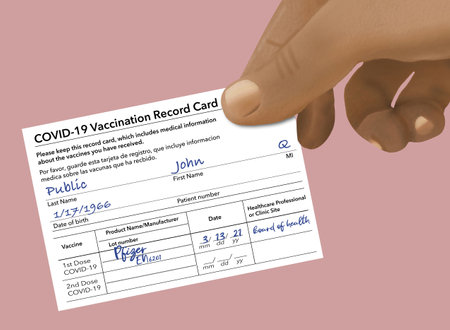 A Covid-19 Vaccination Record Card that is generic and filled out with John Q Publicâs name is held by a hand in this 3-D illustration.の写真素材