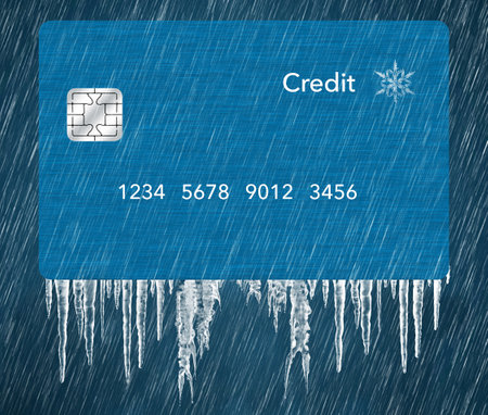A generic blue credit card is seen in a snowstorm with icicles in a 3-d illustration about putting a credit freeze on a credit report.の写真素材