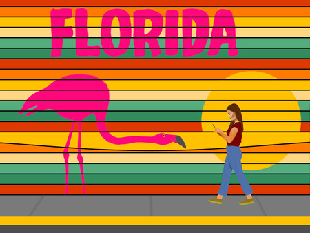 A girl on her phone walks by a very colorful promotional billboard for Florida tourism. A flamingo and sunset are included in the 3-d illustration.の写真素材