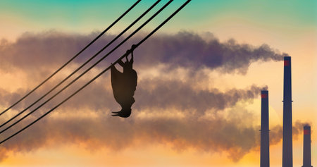 A starling bird hangs dead from a powerline as smoke rolls out of industrial smokestacks in the background. This is a 3-d illustration about air pollution.の写真素材