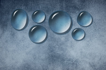 Water droplets are seen on a grunge background in this 3-d illustration about waterproofing or water repellent materials.の写真素材