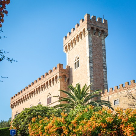castle with tower and city gate of Bolgheri, the village made famous by a poem by Carducci, in Tuscany, Italyのeditorial素材