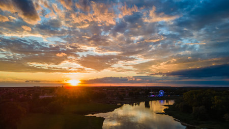 sunset over the town, view of the riverの写真素材