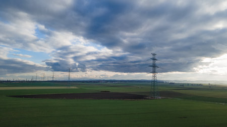 Aerial view of a power line in the middle of a fieldの写真素材