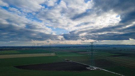 Aerial view of a power line in the middle of a fieldの写真素材