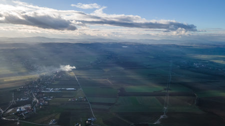 Aerial view of a power line in the middle of a fieldの写真素材