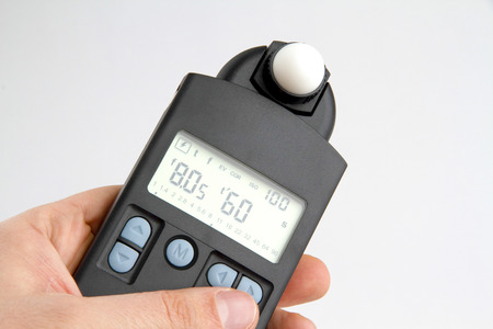 Picture shows a exposure meter in a hand.