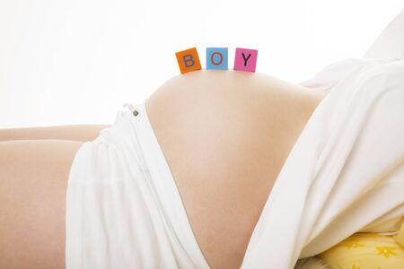 Toy cubes on pregnant bellyの写真素材