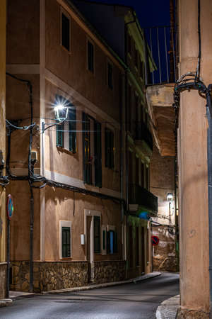 Andratx, Spain - March 21, 2019: Narrow typical Spain street at night lightingのeditorial素材