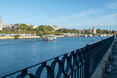 Seville, Spain - November 15, 2019: Romantic river cruise with the golden tower in the backgroundのeditorial素材