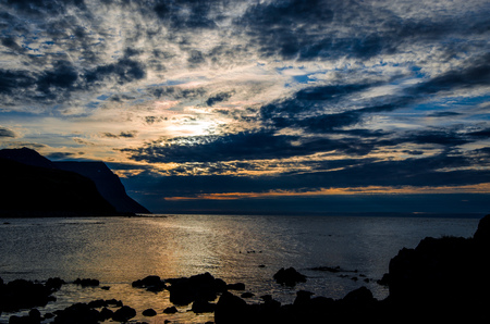 Reflections of sun and clouds at peaceful seaの写真素材