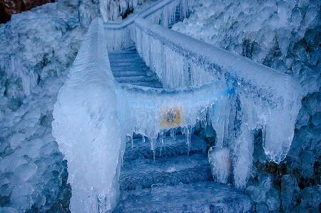 The end of a path by frozen barrier.