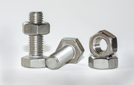 some screws and nuts on white backgroundの写真素材