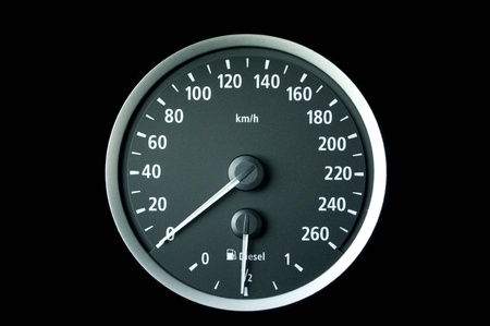 a tachometer on black background