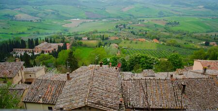 overview of orange roofs of old houses in the Tuscan countrysideの写真素材