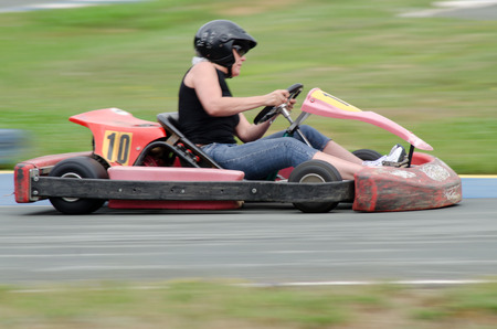 girl runs on go kart: photographed with panning techniqueの写真素材