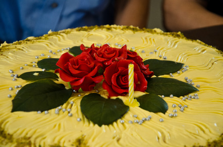sweet cream cake with embossed red roses to celebrate a birthday of eightyの写真素材