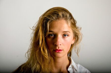 Blonde model posing for photo shoot in a studioの写真素材