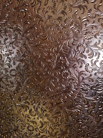 frosted glass texture with patterns of ornamental flowersの写真素材