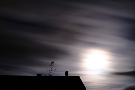 moon that shines like the sun in the trees in the starry nightの写真素材