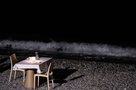 table set for a romantic dinner on the beachの写真素材