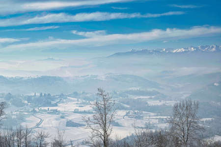 landscape of the Piedmontese Langhe completely covered by the white snows of the winter of 2022 in...